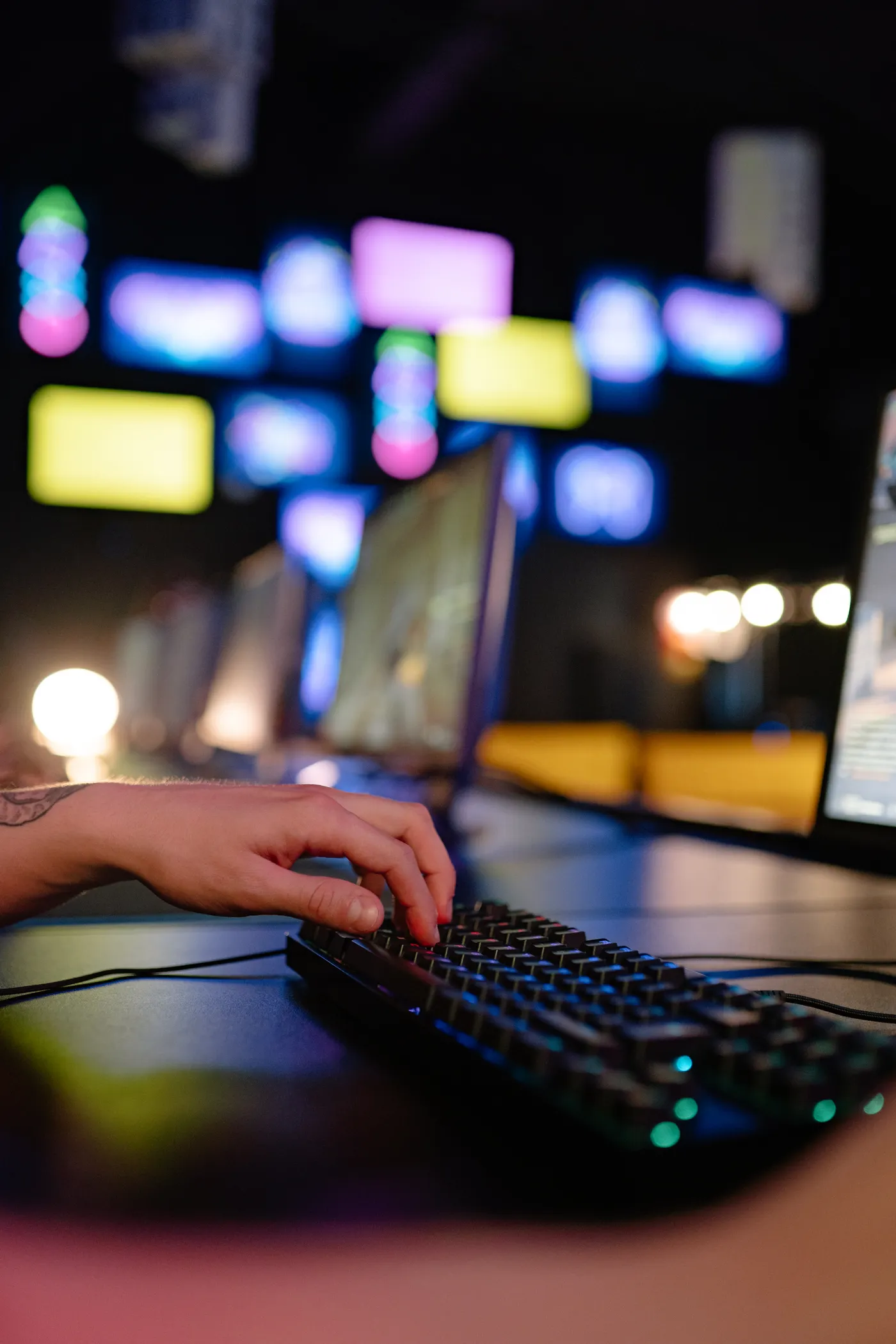 A player using a keyboard in a multiplayer gaming venue.